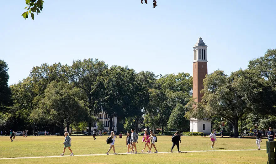Students walking across the Quad near Denny Chimes