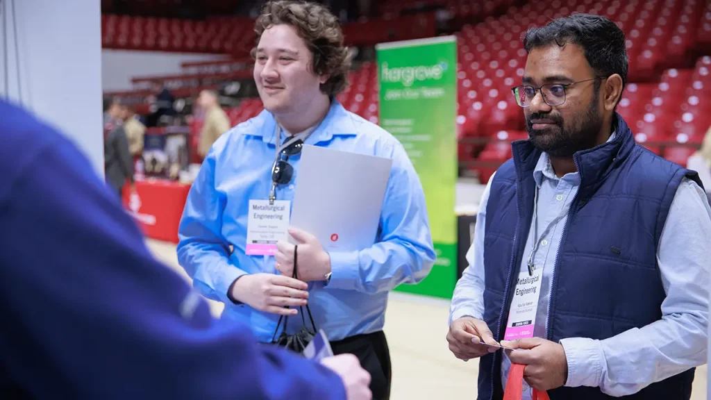 Two students participate in a career fair inside Coleman Coliseum.