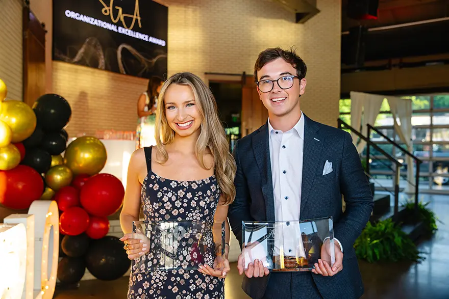 Myles Hudson and another award-winner pose with their awards.