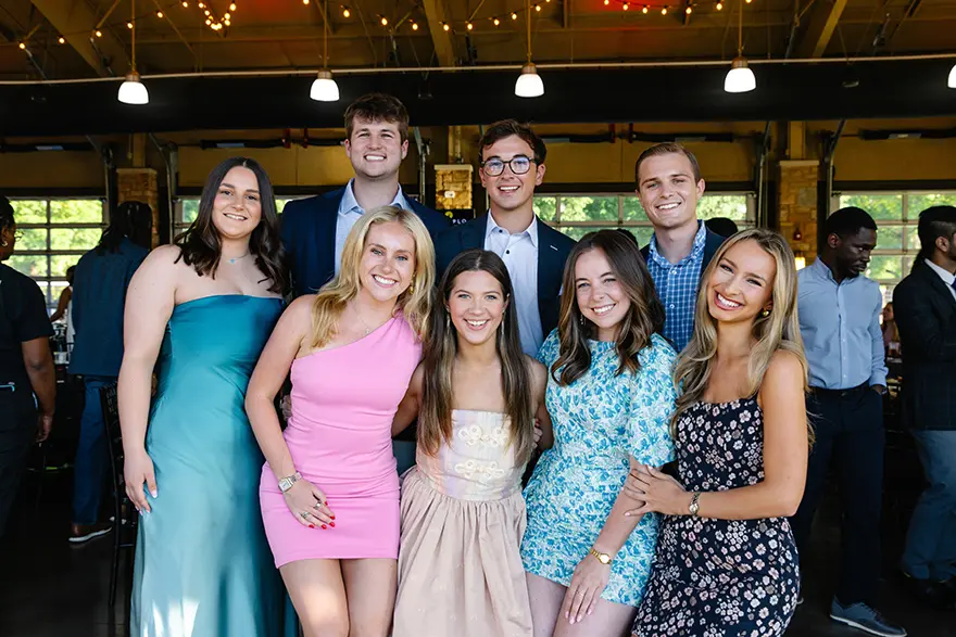 Myles Hudson poses with fellow students from The University of Alabama during an event.