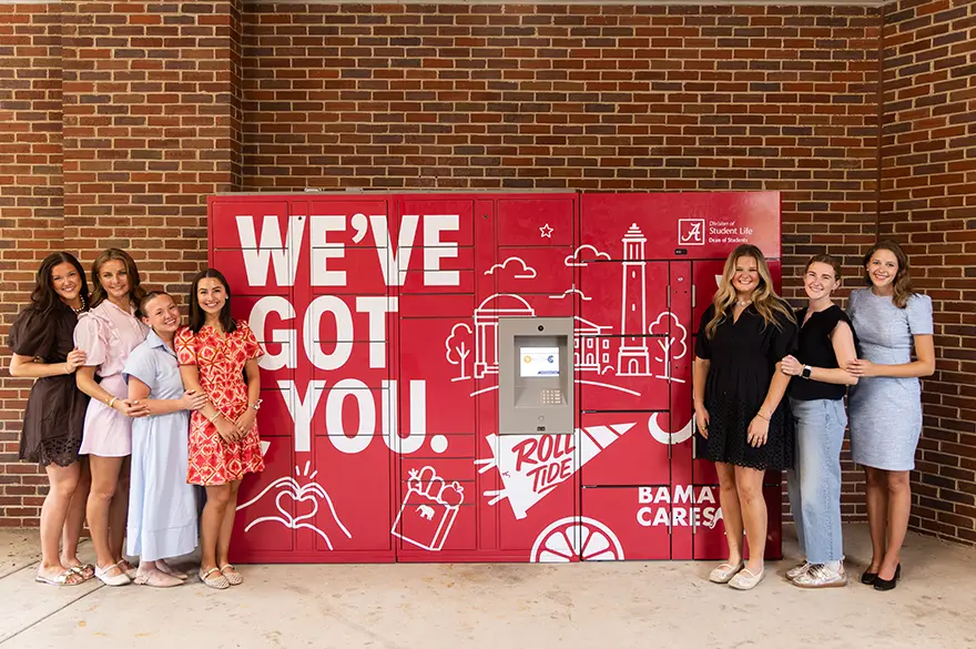 Members of Alpha Gamma Delta in front of the BamaCares food lockers.